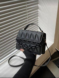 Cartera negra con cadena decorativa